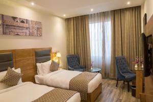 A bed or beds in a room at Regenta Central Cassia Zirakpur Chandigarh