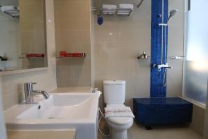 a bathroom with a sink and a toilet and a shower at Moritz Biz Gandaria in Jakarta