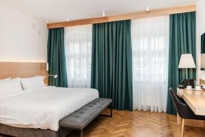 a hotel room with a bed and a desk with a desk at Hotel Casa Luxemburg- Newly Renovated in Sibiu