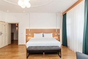 a bedroom with a large bed and a couch at Hotel Casa Luxemburg- Newly Renovated in Sibiu