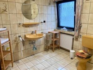 a bathroom with a sink and a toilet at Ferienwohnung "Casa Horife" in Konz