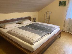 a bedroom with a large bed with a wooden frame at Ferienwohnung "Casa Horife" in Konz