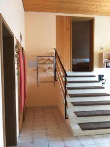 a staircase leading to a room with a bed at Ferienwohnung "Casa Horife" in Konz