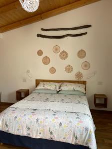 a bedroom with a bed and some plates on the wall at Torremana in Càbras