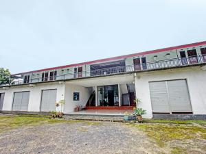 a large white building with doors and a balcony at OYO 92090 Panorama Rinjani Lodge in Labuan Lombok