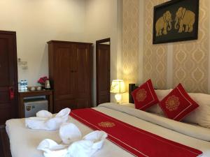 Luang Prabang Pangkham Lodge में एक कमरे में एक या कई बेड