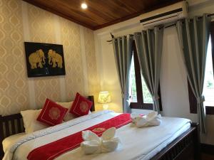 Luang Prabang Pangkham Lodge में एक कमरे में एक या कई बेड