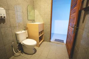 a bathroom with a toilet and a sink at GREEN RINJANI in Bayan