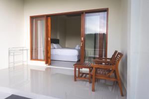 a room with a window and a chair and a bed at GREEN RINJANI in Bayan