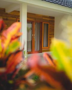 a front door of a house with a window at GREEN RINJANI in Bayan