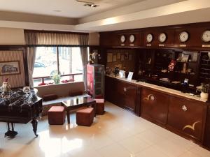 a living room with a table and a counter with clocks at Hotel Bristol in Mostar