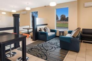 a living room with two chairs and a table at SureStay Plus Hotel by Best Western Jasper in Jasper