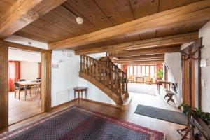 a living room with a wooden staircase and a table at Farbhaus by Kreuz Sachseln in Sachseln