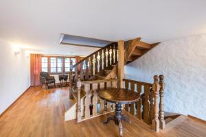 a wooden staircase with a wooden table in a room at Farbhaus by Kreuz Sachseln in Sachseln