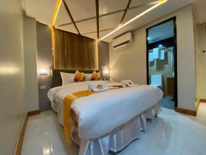 a bedroom with two beds and a large window at NGN Gran Hotel in Tuguegarao City