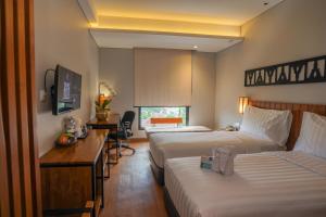 Una cama o camas en una habitación de BATIQA Hotel Lampung