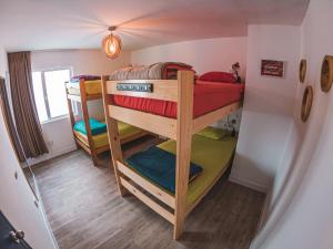 A bed or beds in a room at Alpes Lima Kennedy Hostel