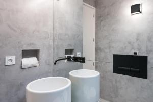 a bathroom with a white toilet and a sink at Door 65 - Historical Center Apartments in Porto