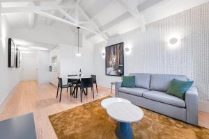 a living room with a couch and a table at Door 65 - Historical Center Apartments in Porto