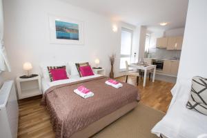 a bedroom with a bed with two towels on it at Bled Apartments in Bled