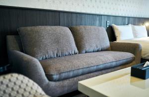 a couch in a hotel room with a bed at Rakuten STAY Kokura Station Standard Twin Room with counter table in Kitakyushu