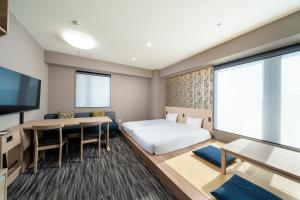 Posteľ alebo postele v izbe v ubytovaní KOKO HOTEL Residence Asakusa Kappabashi