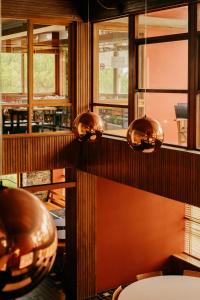 a room with wooden walls and windows and a chair at Parque do Rio Ofir Hotel in Esposende