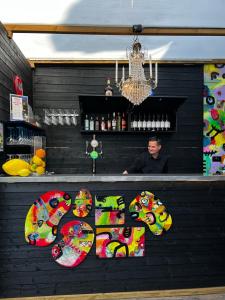 a man standing behind a counter in a bar at Hotell Dannegården in Trelleborg