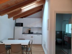 a kitchen and dining room with a table and chairs at Superior Beach Aparthotel in Lido di Jesolo