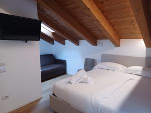 a bedroom with a bed and a flat screen tv at Superior Beach Aparthotel in Lido di Jesolo