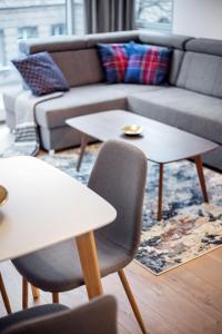 a living room with two tables and a couch at Business Apartment In Jaksto Street in Vilnius