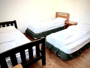 a group of three beds in a room at YETI-clubcom in Gudauri