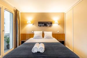 Ένα ή περισσότερα κρεβάτια σε δωμάτιο στο Paris Expo Apart Hotel Porte de Versailles - Parking