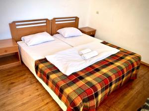 a bedroom with a bed with two towels on it at YETI-clubcom in Gudauri