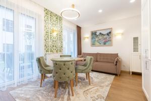 a living room with a table and chairs and a couch at Lux Apartment With A Terrace In Vilnius Old Town in Vilnius