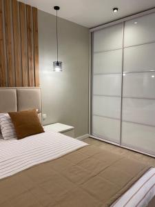 a bedroom with a bed and a sliding glass door at Апартаменты SUOMI в жк Империал in Truskavets