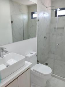 a bathroom with a toilet and a sink and a shower at Venecia 262 in Puerto Vallarta