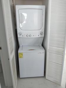 a microwave sitting on top of a small refrigerator at Venecia 262 in Puerto Vallarta