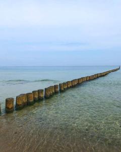 a long pier in the water on a beach at Kite House Chałupy in Władysławowo