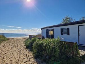 a house on the beach next to a sandy beach at Kite House Chałupy in Władysławowo