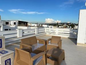 a patio with chairs and a table on a roof at Marsa Central Splendid Appart 2 in La Marsa