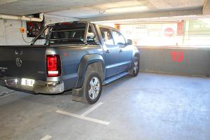 een blauwe pick-up truck geparkeerd in een garage bij Apart Hotel Bauerle & Apartamentos in Temuco