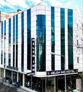 a building with blue and white stripes on it at Helen Inn in Izmir