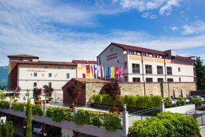 un edificio con banderas delante en Hotel Borgo Brianteo, en Ponte San Pietro