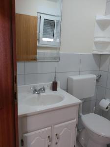 a bathroom with a white sink and a toilet at Apartments Elvir Nin in Nin