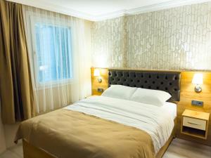 a bedroom with a large bed and a window at Helen Inn in Izmir