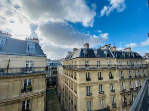 a view of the roofs of buildings in paris at Queens Boutique Hotel in Paris