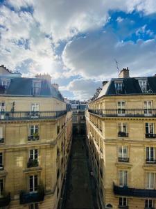 a view of a street between two buildings at Queens Boutique Hotel in Paris