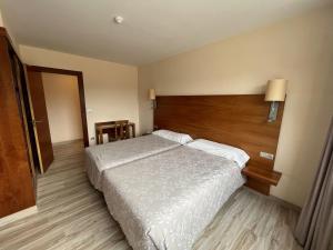 A bed or beds in a room at Apartamentos Astuy