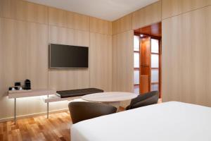 A bed or beds in a room at AC Hotel Málaga Palacio by Marriott